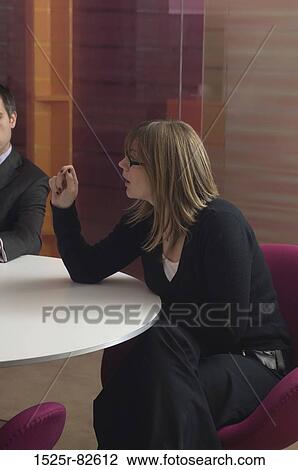 Businessman and a businesswoman talking in an office View Large Photo Image Stock Image - Businessman and a businesswoman talking in an office. Fotosearch