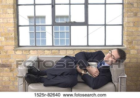 Businessman sleeping on a couch View Large Photo Image Stock Image - Businessman sleeping on a couch. Fotosearch