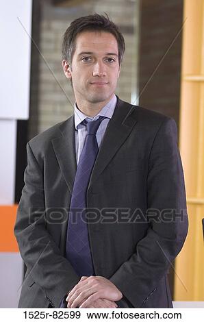 Businessman standing in an office View Large Photo Image Stock Photo - Businessman standing in an office. Fotosearch