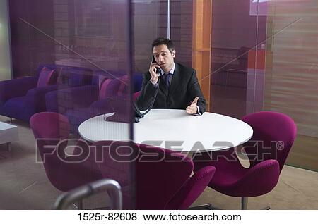 Businessman talking on the telephone in an office View Large Photo Image Stock Photo - Businessman talking on the telephone in an office. Fotosearch