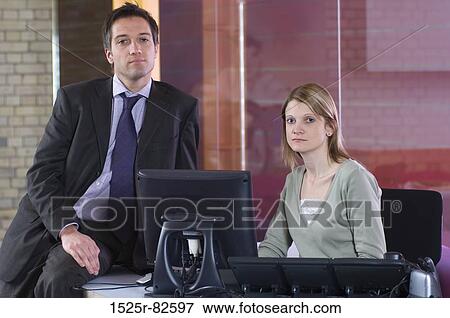 Businessman with a businesswoman sitting in an office View Large Photo Image Stock Photo - Businessman with a businesswoman sitting in an office. Fotosearch