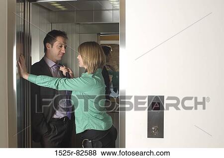 Businesswoman pulling a businessman by his tie in an elevator View Large Photo Image Stock Photo - Businesswoman pulling a businessman by his tie in an elevator. Fotosearch