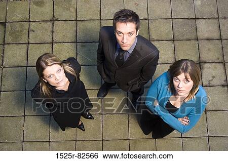 High angle view of a businessman standing with two businesswomen View Large Photo Image Stock Photograph - High angle view of a businessman standing with two businesswomen. Fotosearch