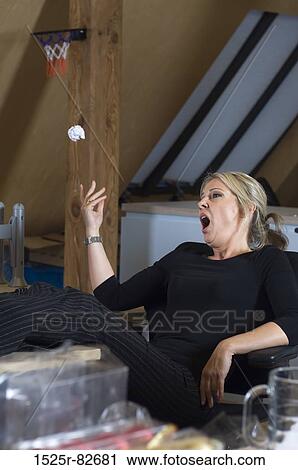 Mid adult woman playing with a crumpled paper ball View Large Photo Image Stock Image - Mid adult woman playing with a crumpled paper ball. Fotosearch