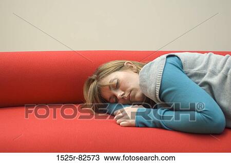 Mid adult woman sleeping on a couch View Large Photo Image Stock Image - Mid adult woman sleeping on a couch. Fotosearch