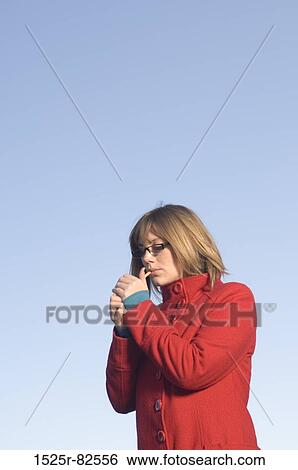 Mid adult woman smoking a cigarette View Large Photo Image Stock Photograph - Mid adult woman smoking a cigarette. Fotosearch