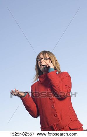 Mid adult woman talking on a mobile phone View Large Photo Image Stock Photo - Mid adult woman talking on a mobile phone. Fotosearch