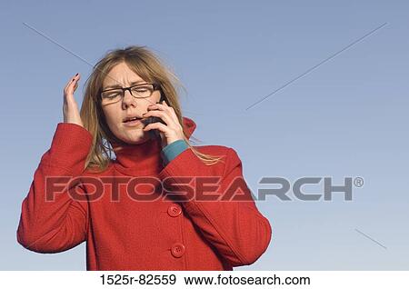 Mid adult woman talking on a mobile phone View Large Photo Image Stock Photo - Mid adult woman talking on a mobile phone. Fotosearch