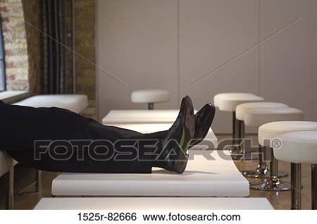 Person's legs on a table View Large Photo Image Stock Photograph - Person's legs on a table. Fotosearch
