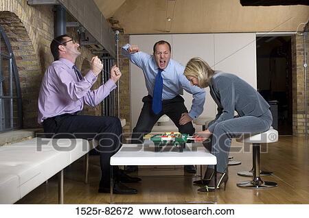 Two businessmen celebrating their success in the game of foosball View Large Photo Image Stock Image - Two businessmen celebrating their success in the game of foosball. Fotosearch