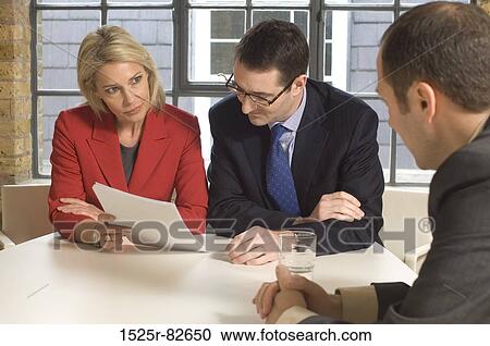 Two businessmen with a businesswoman talking in a meeting View Large Photo Image Stock Image - Two businessmen with a businesswoman talking in a meeting. Fotosearch