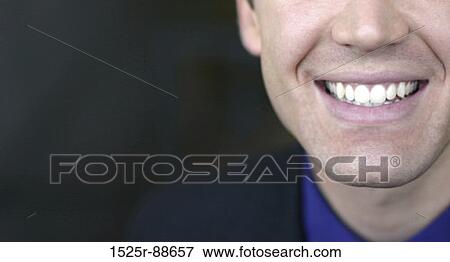 Stock Photo - Business man has big smile against black background. Fotosearch