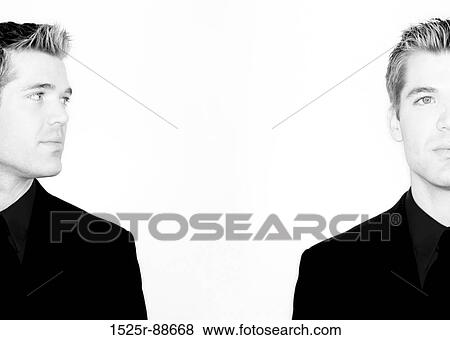 Business man is looking at himself in black and white View Large Photo Image Stock Photo - Business man is looking at himself in black and white. Fotosearch