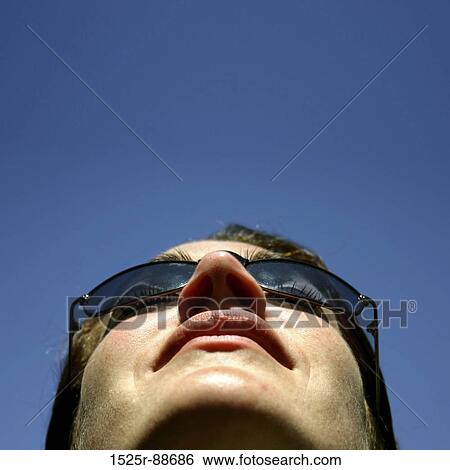 Business woman looks up intot the blue sky with her sunglasses View Large Photo Image Stock Photograph - Business woman looks up intot the blue sky with her sunglasses. Fotosearch