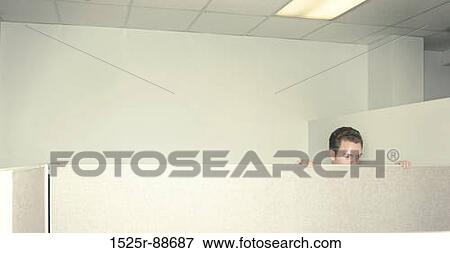 Stock Photo - Businessman looks over the cubical wall at his coworkers in their cubicals. Fotosearch