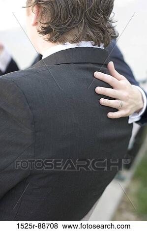 Businessman sitting in a meeting getting care and consoling View Large Photo Image Stock Photo - Businessman sitting in a meeting getting care and consoling. Fotosearch
