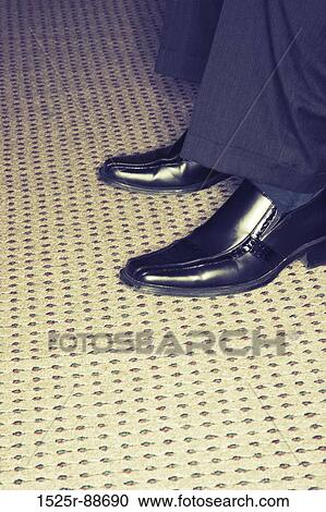 Close-up image of the businessman's work shoes while he's wearing them on the patterned carpet View Large Photo Image Stock Image - Close-up image of the businessman's work shoes while he's wearing them on the patterned carpet. Fotosearch