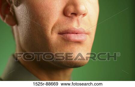 Face of businessman with gray shirt against a green backdrop View Large Photo Image Stock Photo - Face of businessman with gray shirt against a green backdrop. Fotosearch