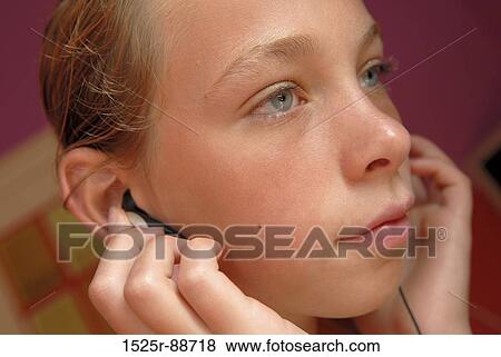 Close-up of a girl listening to music View Large Photo Image Stock Photo - Close-up of a girl listening to music. Fotosearch