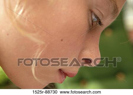 Close-up of a girl looking down View Large Photo Image Stock Image - Close-up of a girl looking down. Fotosearch