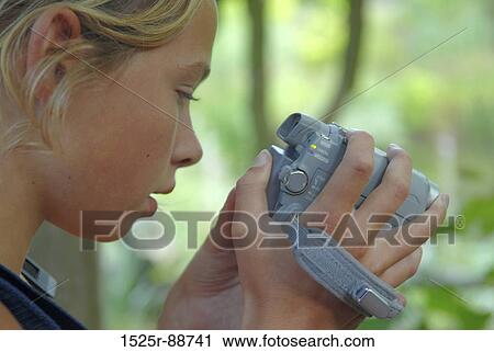 Close-up of a girl using a home video camera View Large Photo Image Stock Image - Close-up of a girl using a home video camera. Fotosearch
