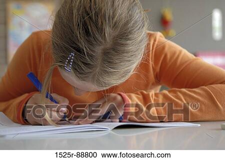 Close-up of a girl writing in a notebook View Large Photo Image Stock Image - Close-up of a girl writing in a notebook. Fotosearch