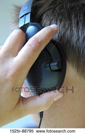 Stock Photography - Close-up of a man listening to headphones. Fotosearch