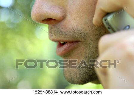 Close-up of a man talking on a mobile phone View Large Photo Image Picture - Close-up of a man talking on a mobile phone. Fotosearch