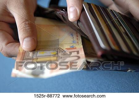 Close-up of a person's hand keeping euro banknotes in a wallet View Large Photo Image Stock Image - Close-up of a person's hand keeping euro banknotes in a wallet. Fotosearch