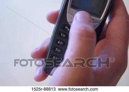 Close-up of a person's hand operating a mobile phone View Large Photo Image Stock Image - Close-up of a person's hand operating a mobile phone. Fotosearch