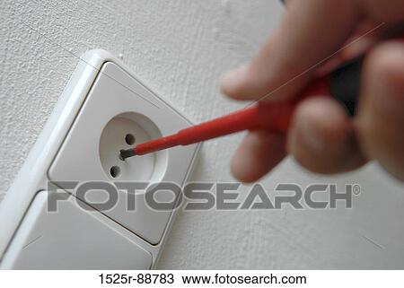 Close-up of a person's hand repairing a wall plug View Large Photo Image Stock Image - Close-up of a person's hand repairing a wall plug. Fotosearch