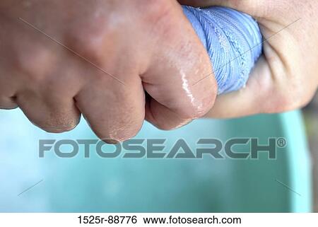 Stock Photograph - Close-up of a person's hand squeezing a cloth. Fotosearch