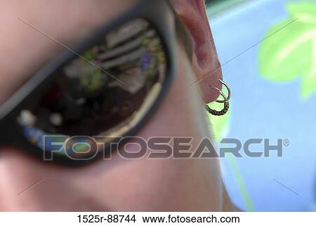 Close-up of a woman wearing sunglasses View Large Photo Image Picture - Close-up of a woman wearing sunglasses. Fotosearch