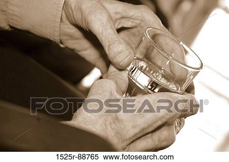 Close-up of a woman's hand holding a glass of water View Large Photo Image Stock Photography - Close-up of a woman's hand holding a glass of water. Fotosearch