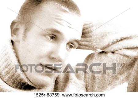 Close-up of a young man thinking View Large Photo Image Stock Photo - Close-up of a young man thinking. Fotosearch