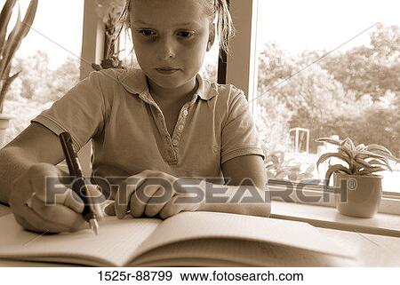 Girl writing in a notebook View Large Photo Image Stock Photo - Girl writing in a notebook. Fotosearch
