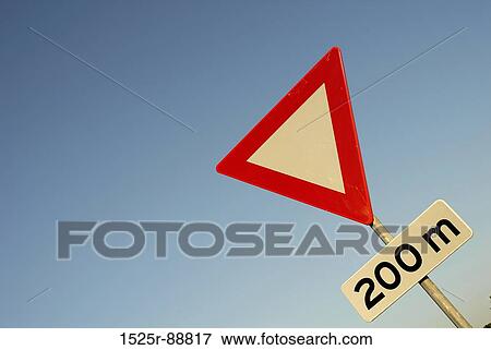 Low angle view of a yield sign View Large Photo Image Stock Photo - Low angle view of a yield sign. Fotosearch