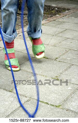 Low section view of a girl skipping View Large Photo Image Stock Photo - Low section view of a girl skipping. Fotosearch