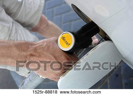 Low section view of a man refueling a car View Large Photo Image Stock Photo - Low section view of a man refueling a car. Fotosearch