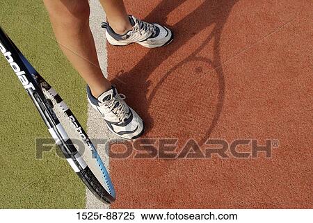 Low section view of a person with a tennis racket View Large Photo Image Stock Photography - Low section view of a person with a tennis racket. Fotosearch