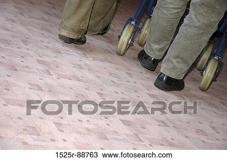 Low section view of two people with a luggage cart View Large Photo Image Stock Image - Low section view of two people with a luggage cart. Fotosearch