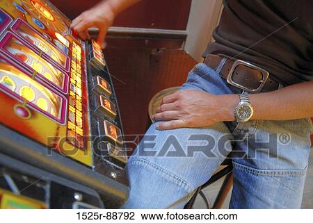Mid section view of a man playing on a slot machine in a casino View Large Photo Image Stock Image - Mid section view of a man playing on a slot machine in a casino. Fotosearch