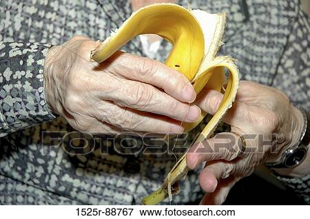 Mid section view of a senior man peeling a banana View Large Photo Image Stock Photo - Mid section view of a senior man peeling a banana. Fotosearch