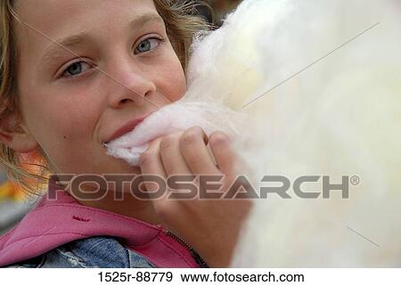 Portrait of a girl eating cotton candy View Large Photo Image Stock Photo - Portrait of a girl eating cotton candy. Fotosearch
