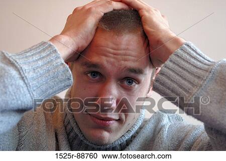 Portrait of a young man with his hands on his head View Large Photo Image Stock Image - Portrait of a young man with his hands on his head. Fotosearch