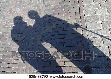 Shadow of two people on the road View Large Photo Image Stock Image - Shadow of two people on the road. Fotosearch