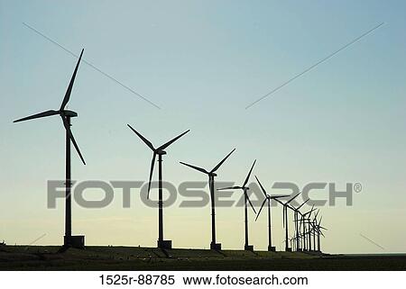 Stock Photography - Silhouette of wind turbines on a landscape. Fotosearch