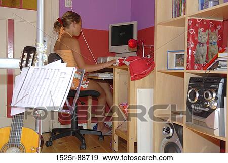 Teenage girl using a computer View Large Photo Image Stock Photo - Teenage girl using a computer. Fotosearch