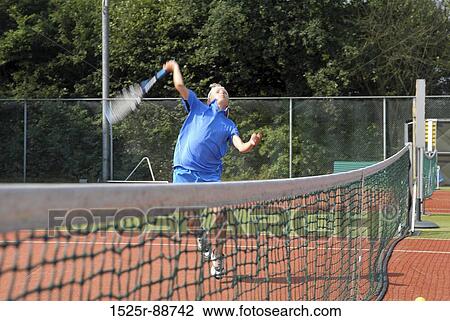 Young man playing tennis View Large Photo Image Stock Image - Young man playing tennis. Fotosearch