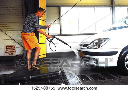 Young man washing a car in a car wash View Large Photo Image Stock Photography - Young man washing a car in a car wash. Fotosearch